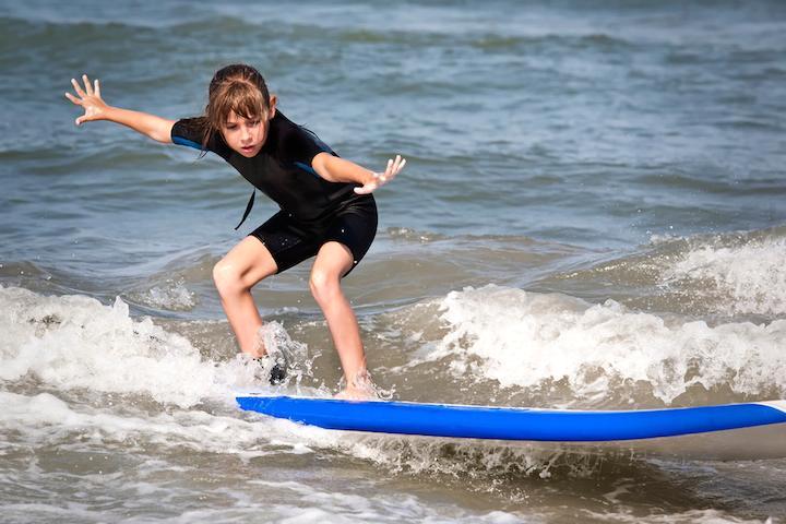 kid surfing in shorty optimised